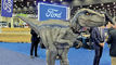 Dinosaurs up to 28 feet tall adorn the hall — one even walks around — in an effort to attract families to the Detroit show.